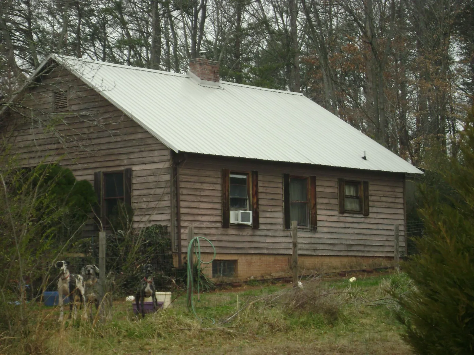 White metal roof on an old wood sided farmhouse, from a Metal Roof Installation job in Galena