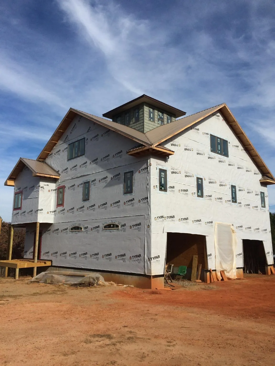 New two story house under construction with a cupola and gabled roofs in Galena